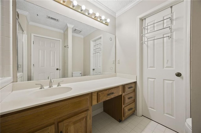 bathroom with tile patterned floors, toilet, a textured ceiling, vanity, and crown molding