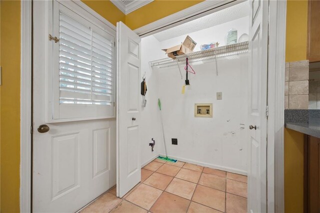 washroom with washer hookup, light tile patterned flooring, and ornamental molding