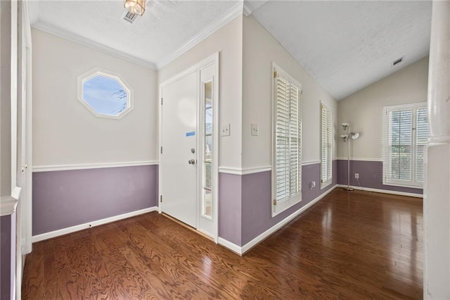 entryway with hardwood / wood-style floors, vaulted ceiling, crown molding, and a textured ceiling