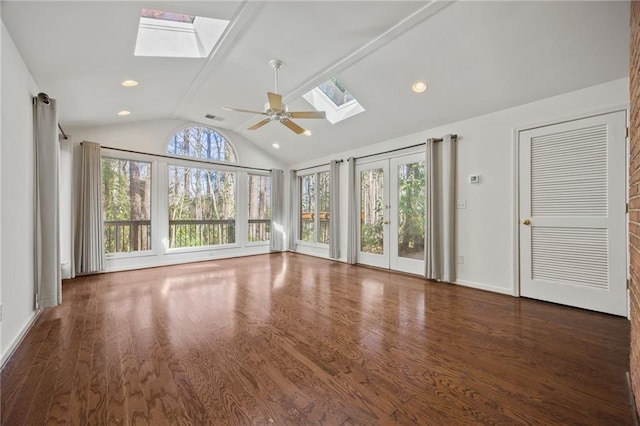 interior space with dark hardwood / wood-style flooring, ceiling fan, and lofted ceiling with skylight