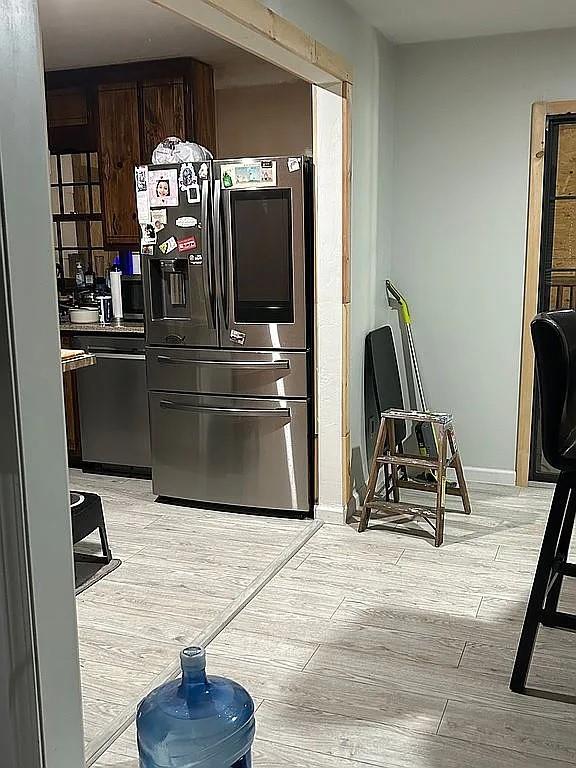 170 Beatrice St, Dallas, GA 30157 - kitchen with light wood finished floors, stainless steel fridge with ice dispenser, dark brown cabinetry, and dishwasher