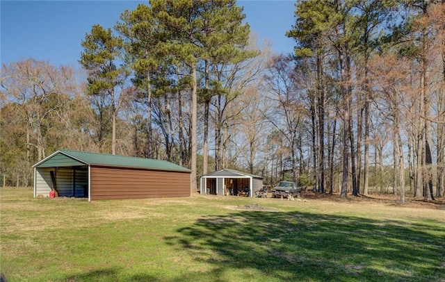 view of yard with a carport, an outbuilding, and a pole building