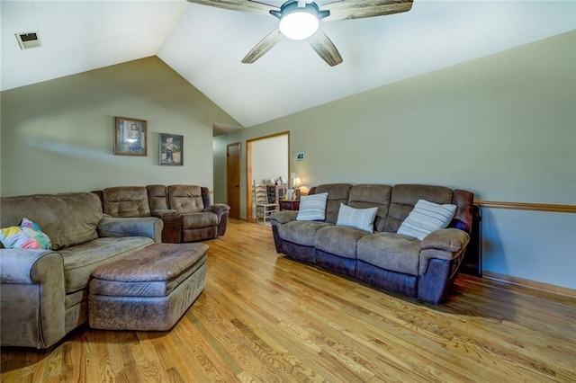 living area with vaulted ceiling, visible vents, ceiling fan, and light wood-style flooring