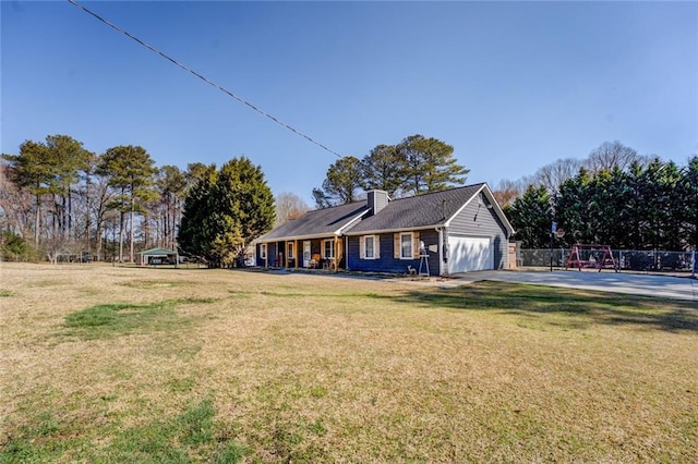 view of front of house with a chimney, a front yard, fence, a garage, and driveway