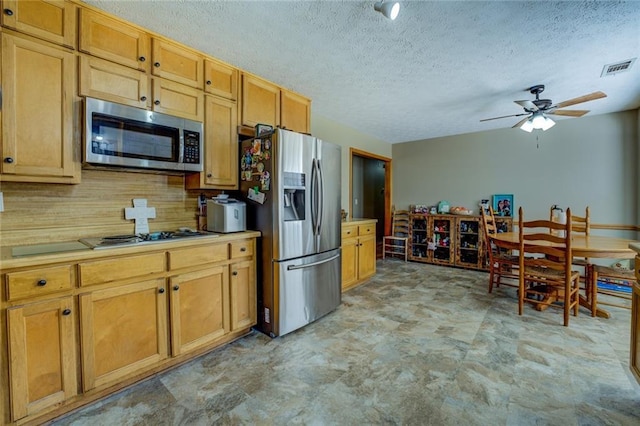 kitchen featuring stainless steel appliances, light countertops, visible vents, decorative backsplash, and a ceiling fan