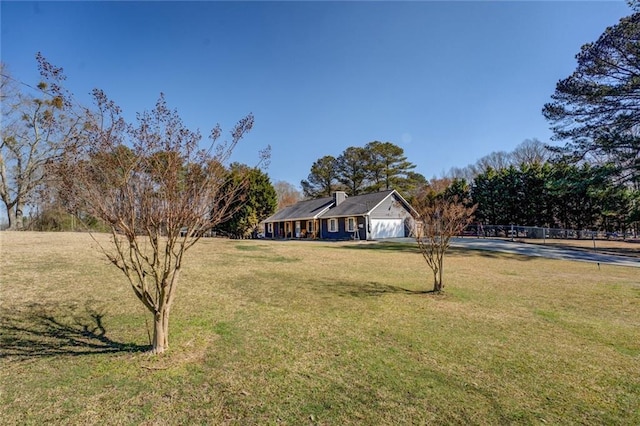 view of front of house with a garage and a front lawn