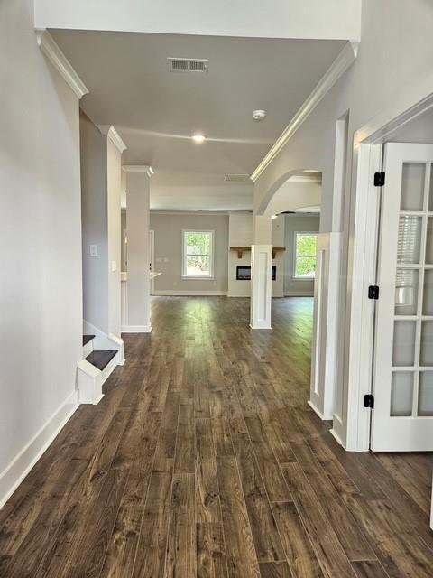 222 Silvercrest Dr, Acworth, GA 30101 - hall featuring crown molding, arched walkways, dark wood finished floors, and baseboards