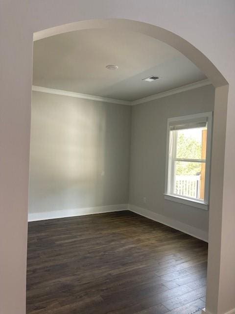 222 Silvercrest Dr, Acworth, GA 30101 - unfurnished room featuring arched walkways, crown molding, dark wood finished floors, and baseboards