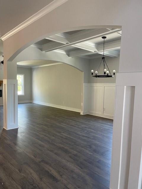 222 Silvercrest Dr, Acworth, GA 30101 - unfurnished dining area featuring arched walkways, a chandelier, dark wood finished floors, coffered ceiling, and beam ceiling