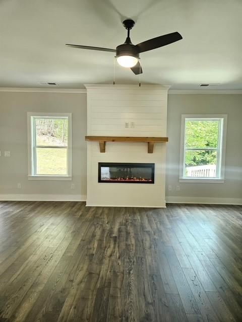 222 Silvercrest Dr, Acworth, GA 30101 - unfurnished living room featuring crown molding, baseboards, a fireplace, dark wood finished floors, and ceiling fan