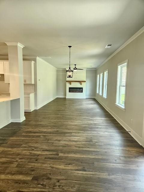 222 Silvercrest Dr, Acworth, GA 30101 - unfurnished living room featuring ornamental molding, baseboards, dark wood finished floors, and a fireplace
