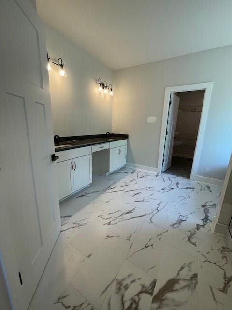 222 Silvercrest Dr, Acworth, GA 30101 - bathroom with vanity, baseboards, marble finish flooring, and a spacious closet