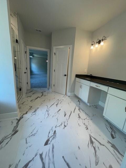 222 Silvercrest Dr, Acworth, GA 30101 - bathroom featuring vanity, a marble finish shower, baseboards, and marble finish floors
