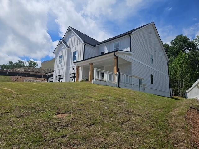 222 Silvercrest Dr, Acworth, GA 30101 - back of house with a yard, board and batten siding, and a porch
