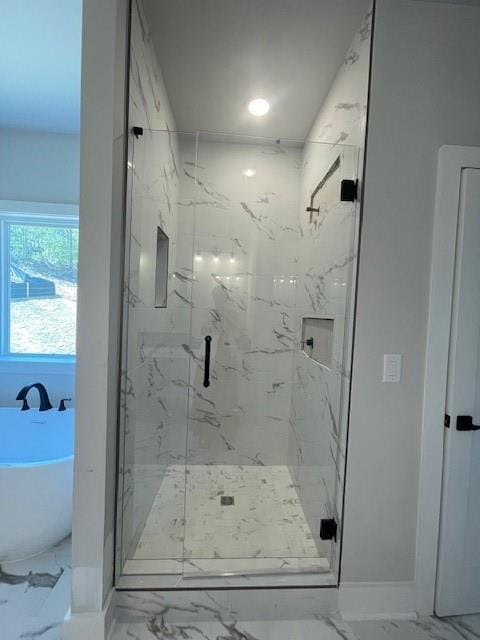 222 Silvercrest Dr, Acworth, GA 30101 - bathroom featuring marble finish floors, a soaking tub, and a marble finish shower