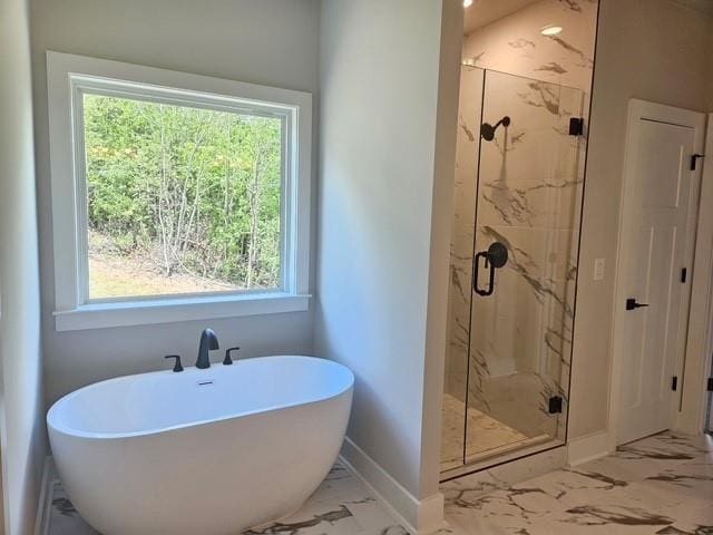 222 Silvercrest Dr, Acworth, GA 30101 - bathroom with marble look tile flooring, a soaking tub, baseboards, a marble finish shower, and healthy amount of natural light