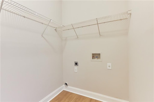 washroom featuring laundry area, hookup for a washing machine, baseboards, light wood-type flooring, and hookup for an electric dryer