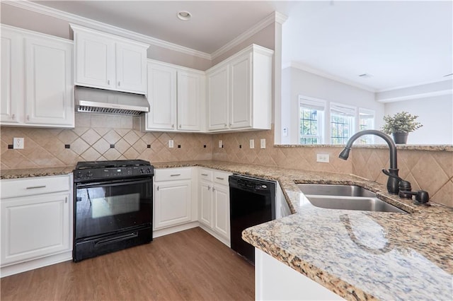 kitchen with exhaust hood, wood finished floors, a sink, white cabinets, and black appliances