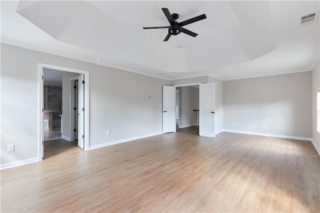 unfurnished bedroom with baseboards, ornamental molding, light wood finished floors, and visible vents