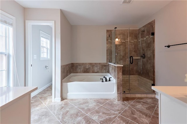 full bath featuring a garden tub, vanity, visible vents, tile patterned floors, and a shower stall