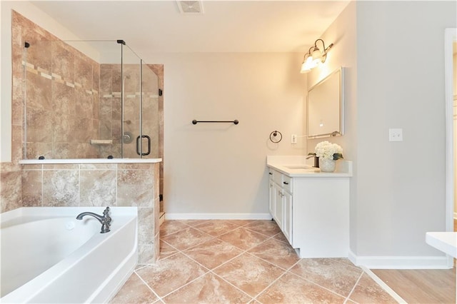 full bath featuring a garden tub, visible vents, a stall shower, vanity, and baseboards