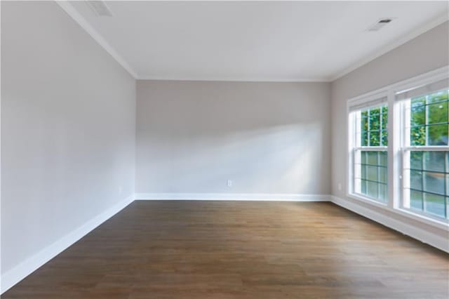 spare room with baseboards and ornamental molding