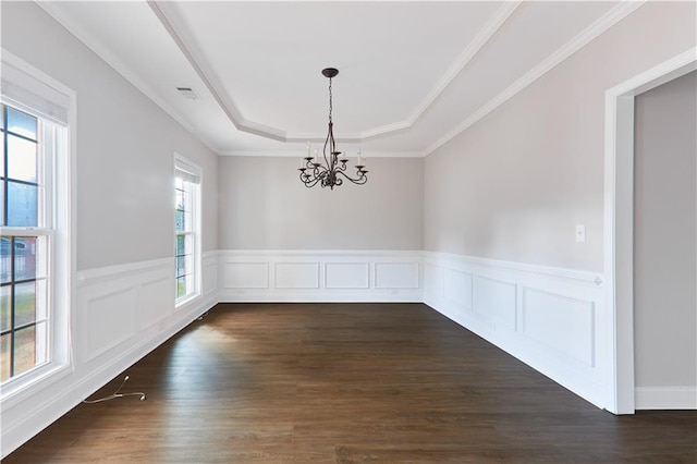 unfurnished dining area with visible vents, a raised ceiling, a notable chandelier, and dark wood finished floors