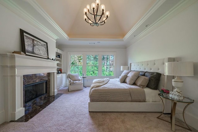 bedroom with a chandelier, light colored carpet, a premium fireplace, ornamental molding, and a raised ceiling