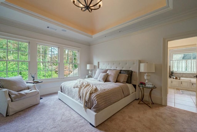 carpeted bedroom with a notable chandelier, multiple windows, ornamental molding, and a tray ceiling