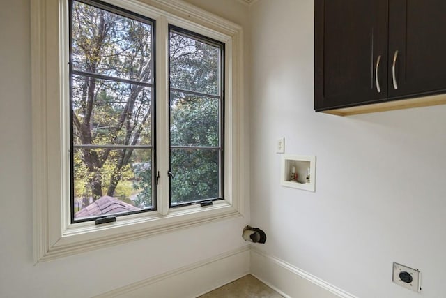 washroom featuring washer hookup, hookup for an electric dryer, cabinets, and a wealth of natural light