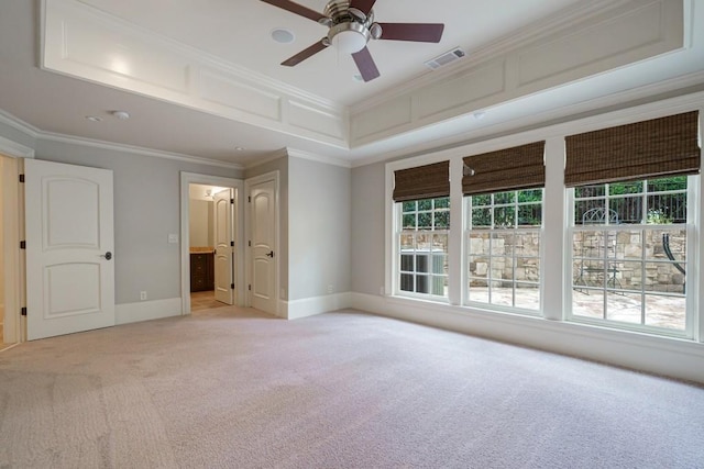 carpeted spare room featuring crown molding, ceiling fan, and a healthy amount of sunlight