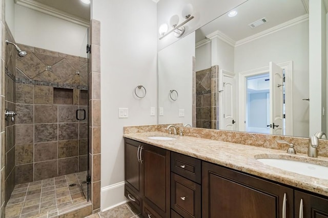 bathroom featuring walk in shower, tile floors, dual sinks, vanity with extensive cabinet space, and crown molding