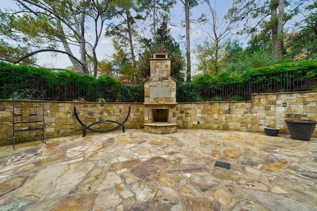 view of patio / terrace featuring an outdoor stone fireplace