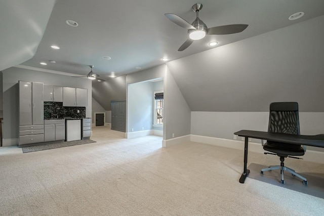 home office featuring sink, ceiling fan, vaulted ceiling, and light colored carpet