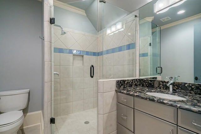 bathroom with vanity, crown molding, a shower with door, and toilet