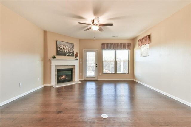 unfurnished living room with ceiling fan and dark hardwood / wood-style flooring