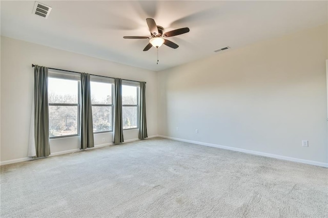 empty room with light colored carpet and ceiling fan