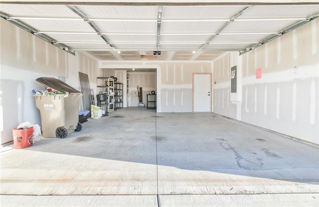 garage featuring electric panel and a garage door opener