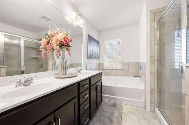 bathroom featuring double vanity, a stall shower, a bath, visible vents, and a sink