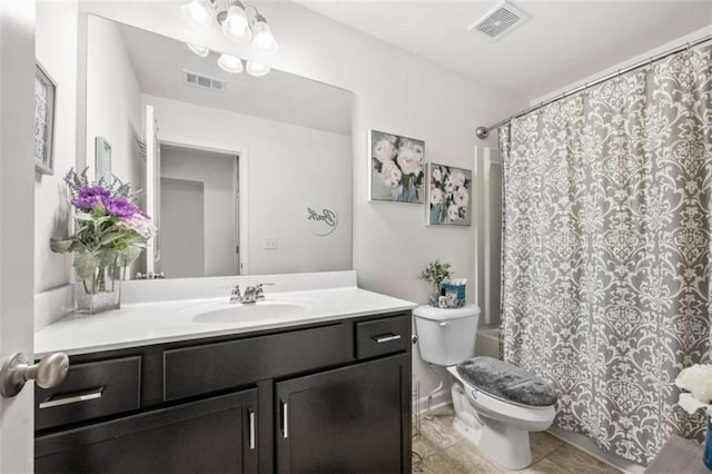 bathroom featuring visible vents, toilet, vanity, and tile patterned flooring