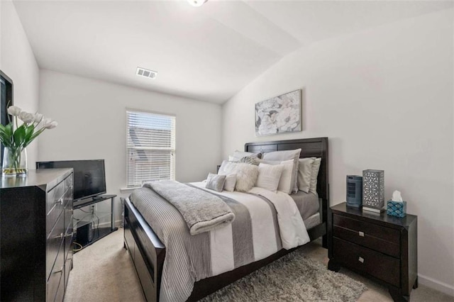 bedroom with visible vents, baseboards, vaulted ceiling, and light carpet