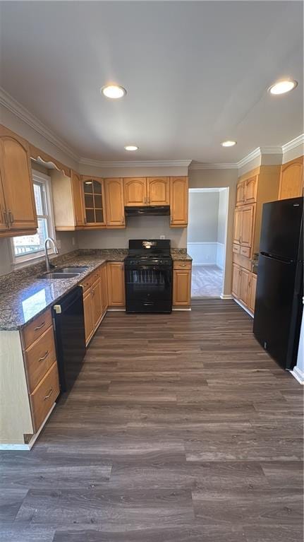 kitchen with dark wood-style floors, crown molding, glass insert cabinets, a sink, and black appliances