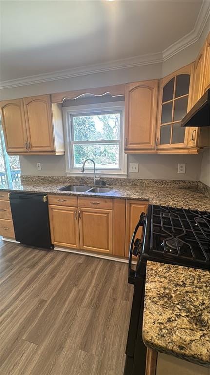 kitchen with range with gas stovetop, black dishwasher, glass insert cabinets, ornamental molding, and a sink