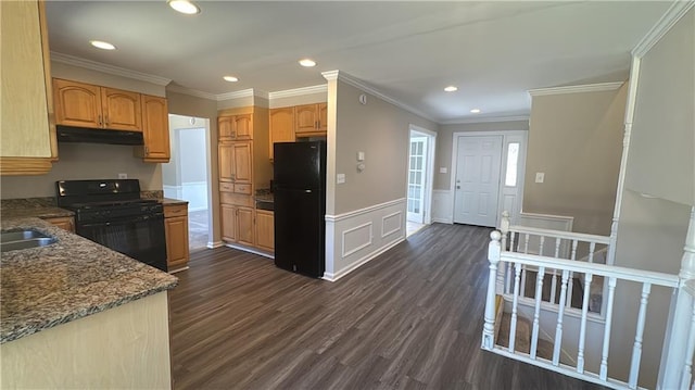 kitchen with dark wood-style floors, black appliances, wainscoting, and under cabinet range hood