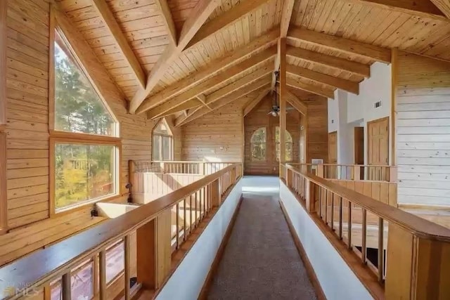 524 Bethany Church Rd SW, Crawfordville, GA 30631 - corridor featuring wood ceiling, wood walls, vaulted ceiling with beams, and an upstairs landing