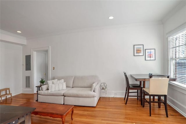 690 Piedmont Ave NE Unit 17, Atlanta, GA 30308 - living room with plenty of natural light, ornamental molding, light wood-style flooring, electric panel, and recessed lighting