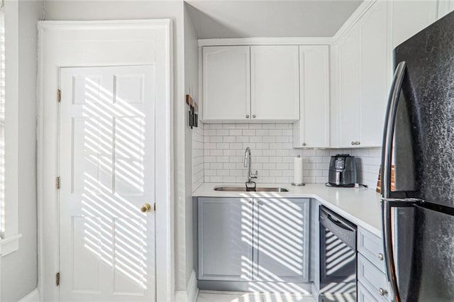 690 Piedmont Ave NE Unit 17, Atlanta, GA 30308 - kitchen featuring freestanding refrigerator, a sink, white cabinetry, backsplash, and light countertops