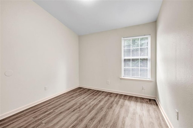 empty room with light hardwood / wood-style flooring