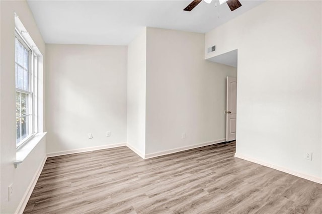 empty room with light hardwood / wood-style floors and ceiling fan