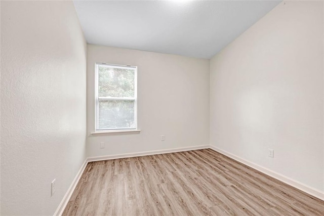 spare room featuring light hardwood / wood-style floors